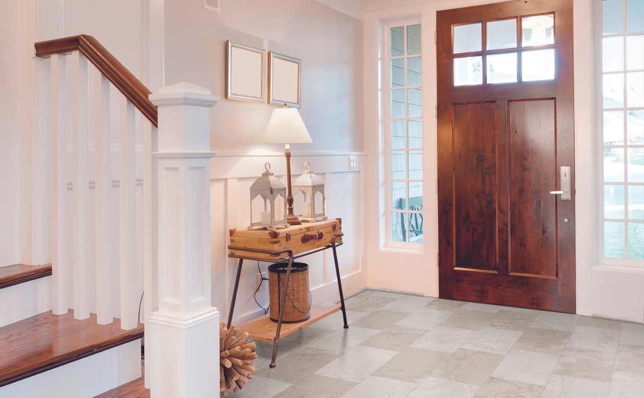 natural stone look luxury vinyl tile in modern entryway with wood accents
